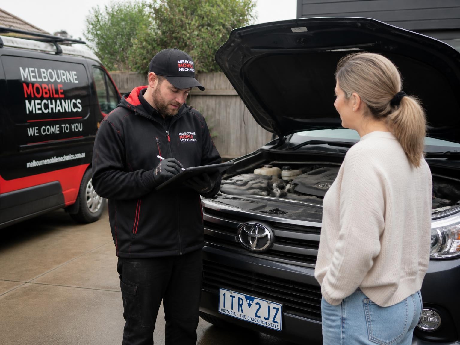 Mobile mechanic completing an on-site vehicle inspection
