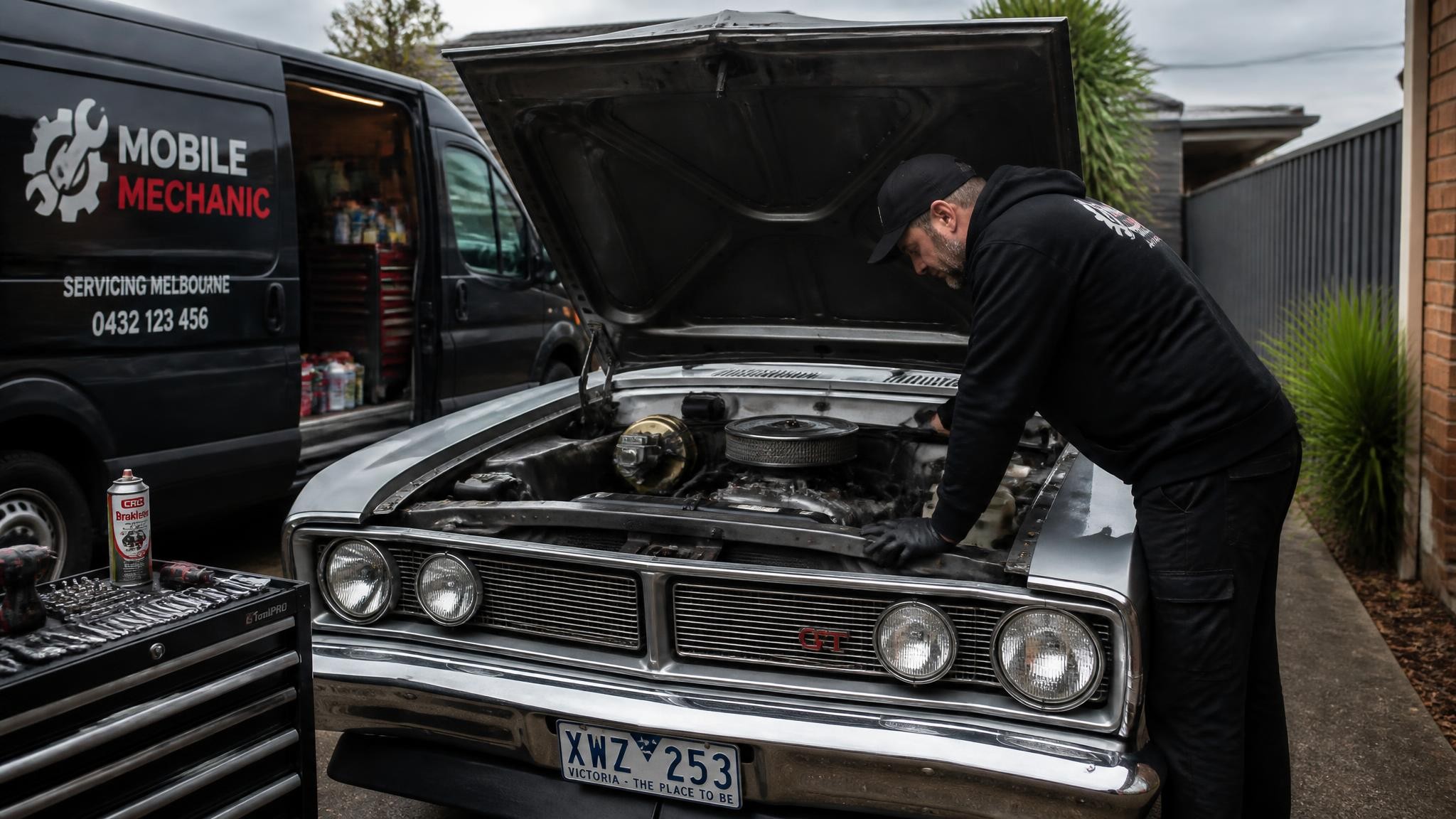 Mechanic inspecting an old car in Melbourne